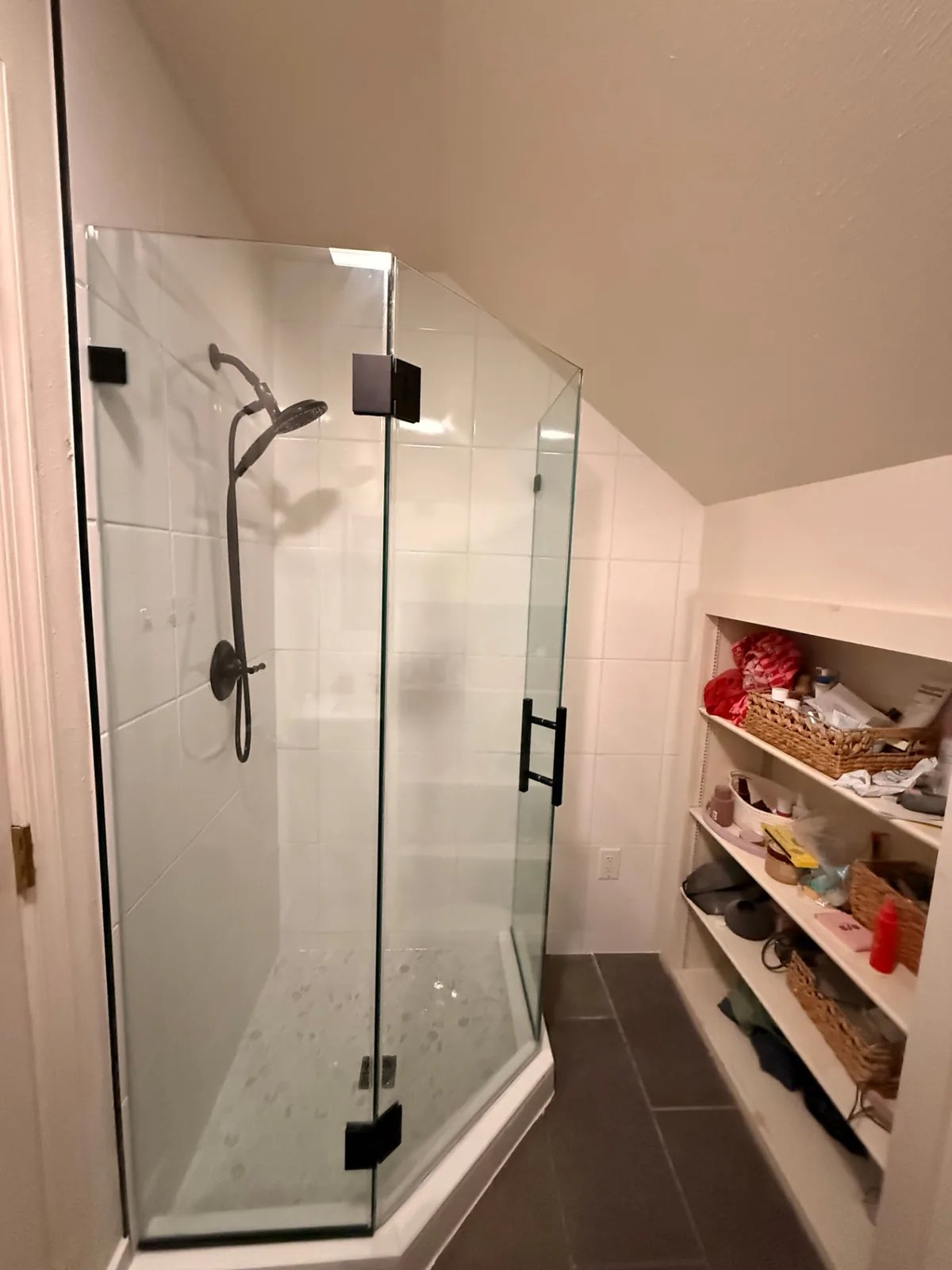 Bathroom remodel with frameless glass corner shower, white tile surround, and slate floor tile