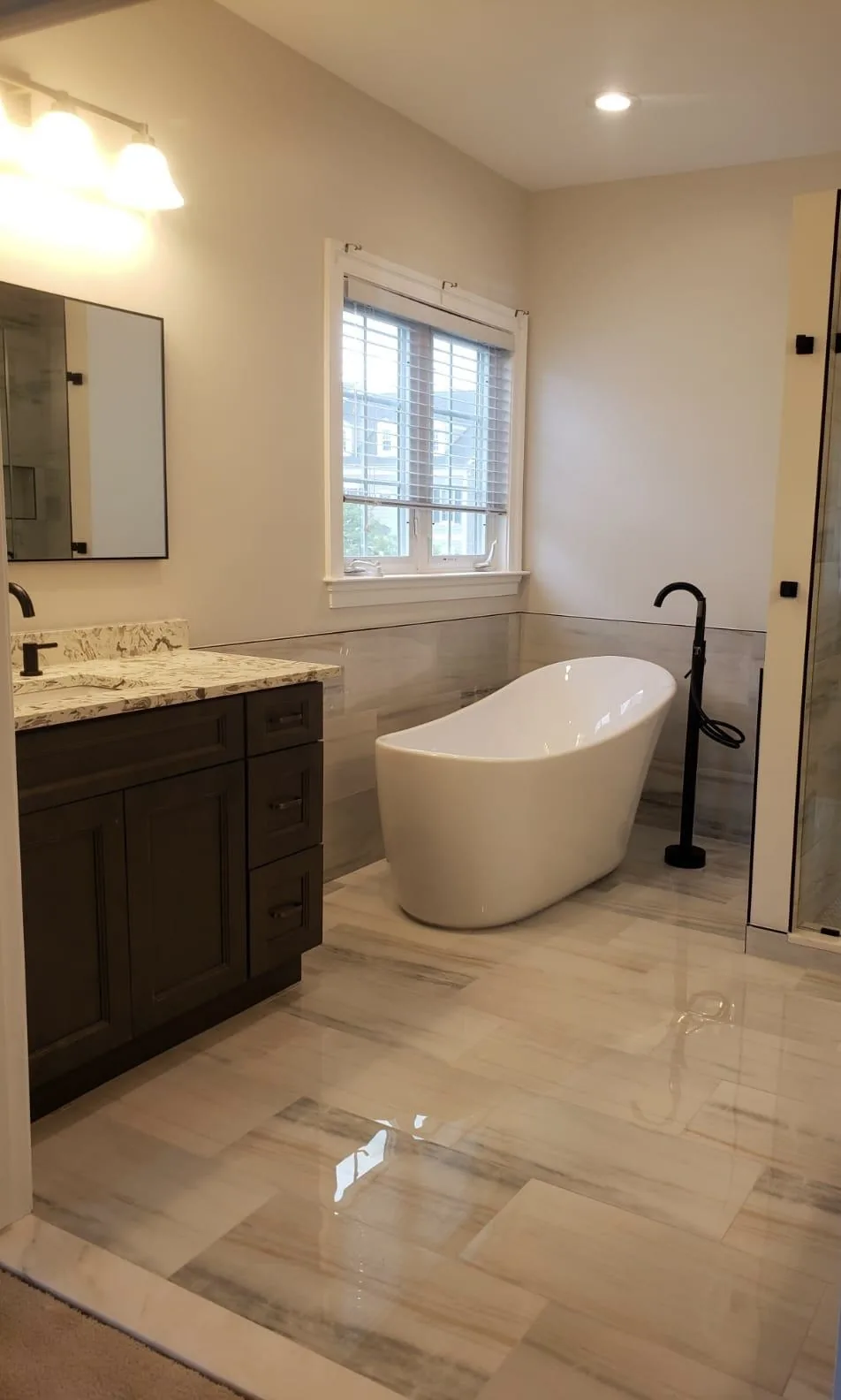 Freestanding tub with marble tile flooring, Fairfax VA master bathroom remodel