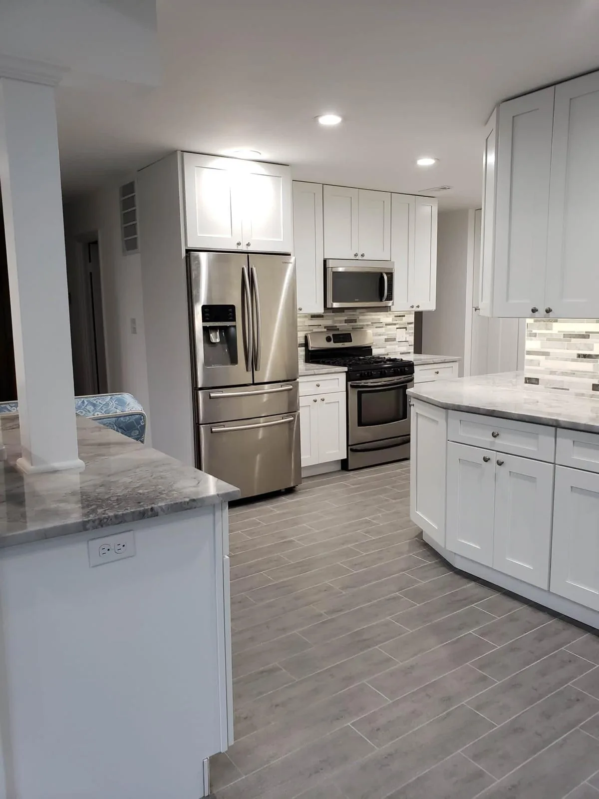 Full kitchen remodel with white cabinetry and stone backsplash, Fairfax VA